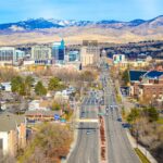 The Boise, Idaho capitol building rises above the city skyline in an urban cityscape.