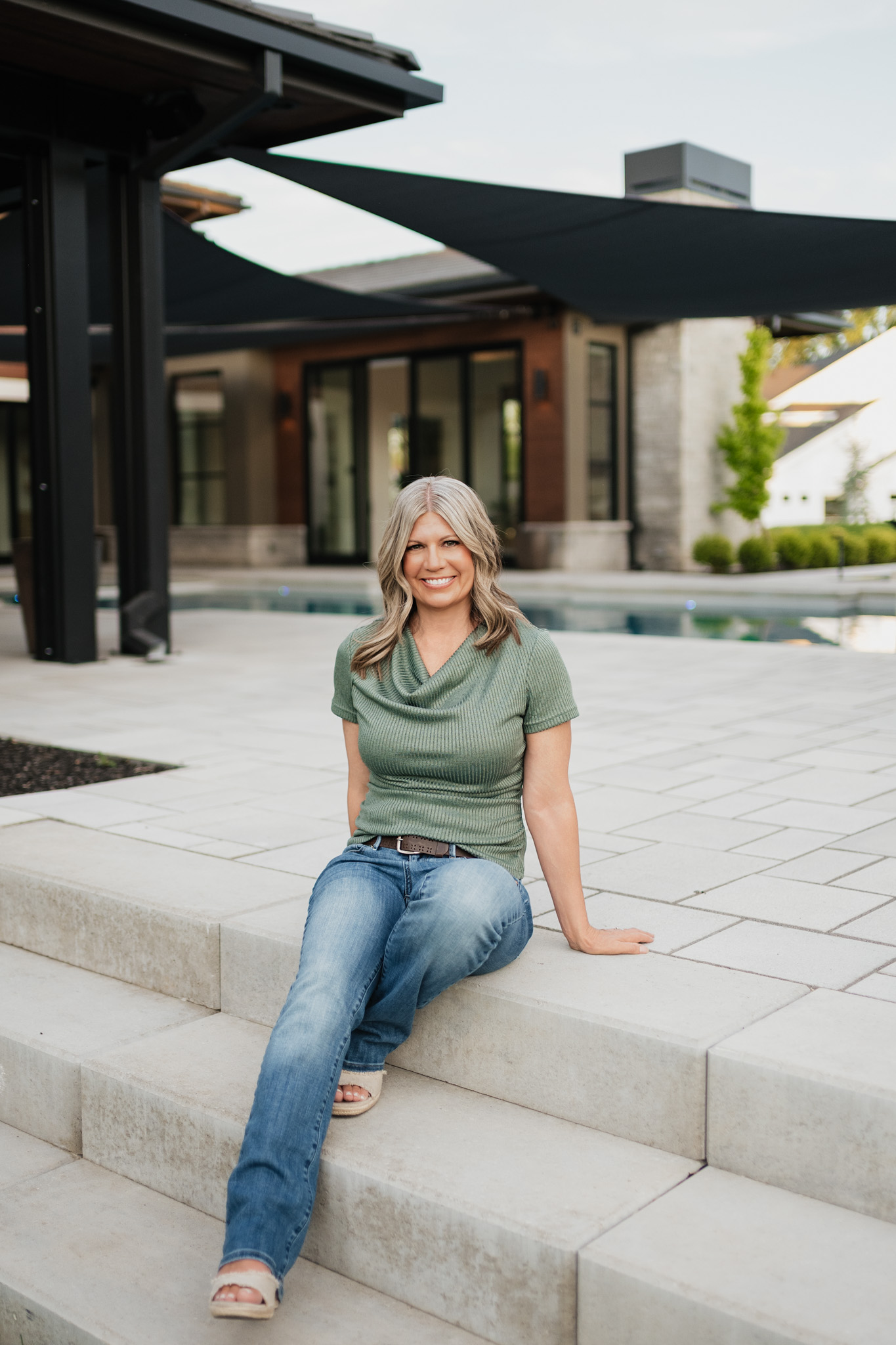Tracie McDonald sitting on the front steps of a home