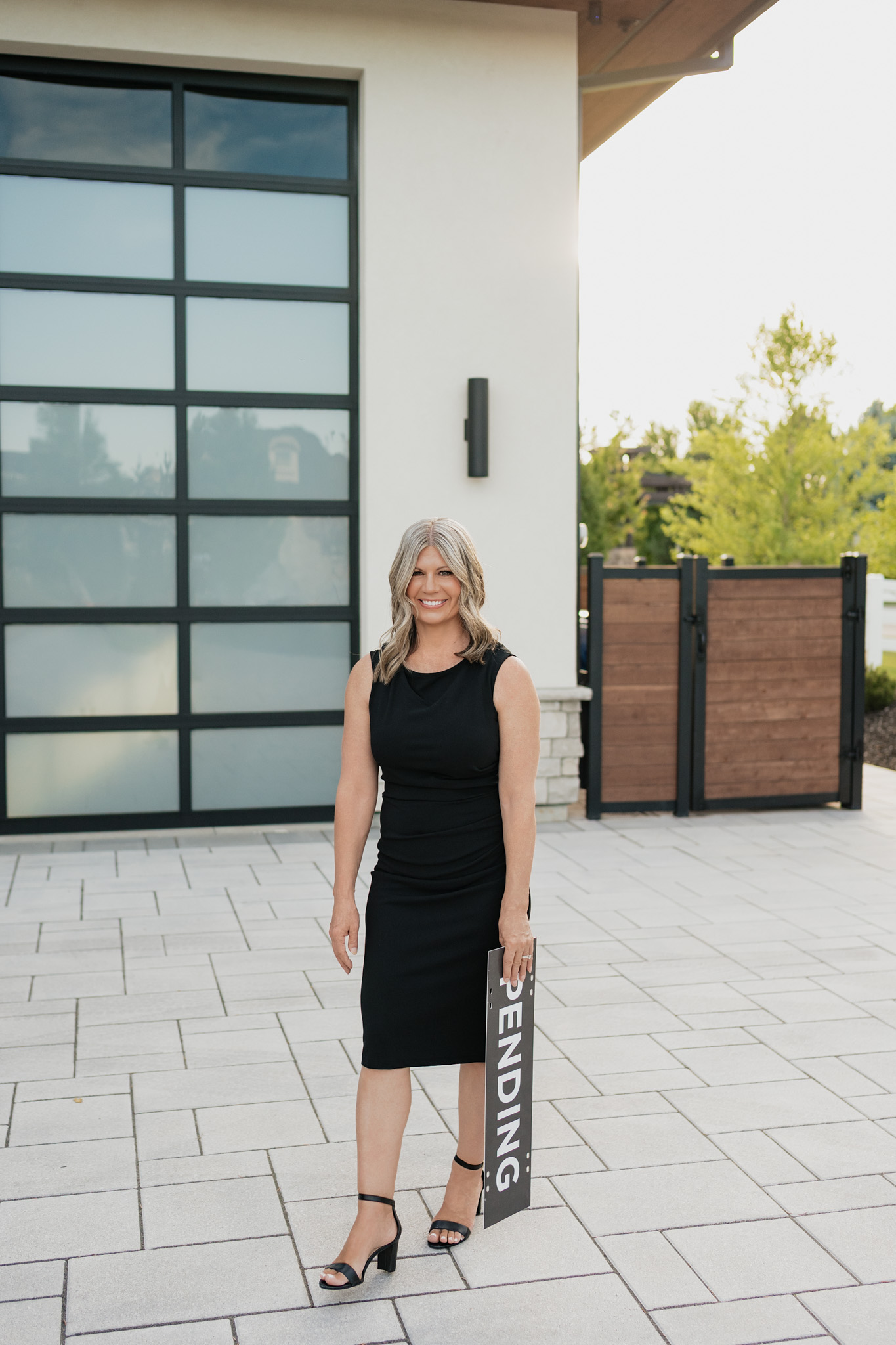 Tracie McDonald standing in front of a home