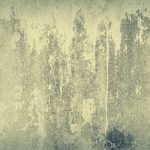 Close-up of an aged, weathered concrete wall with a rough, grunge-textured surface and abstract patterns.