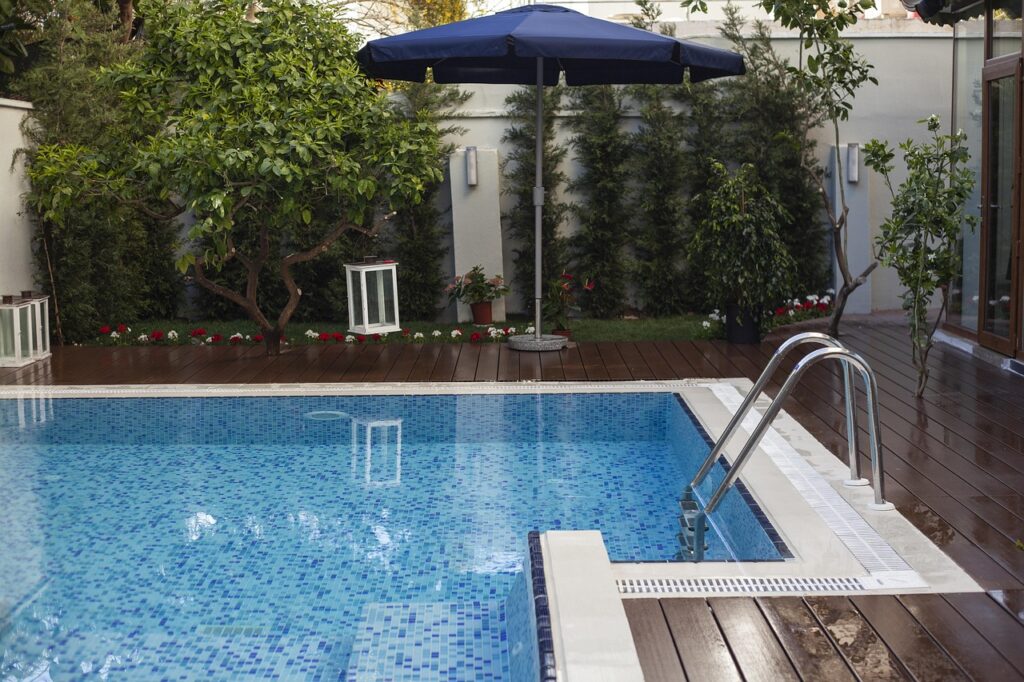 A luxury villa with a blue outdoor swimming pool and architectural exterior design.