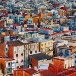 A dense residential neighborhood with rows of houses, apartment buildings, and rooftops spread across an urban area.