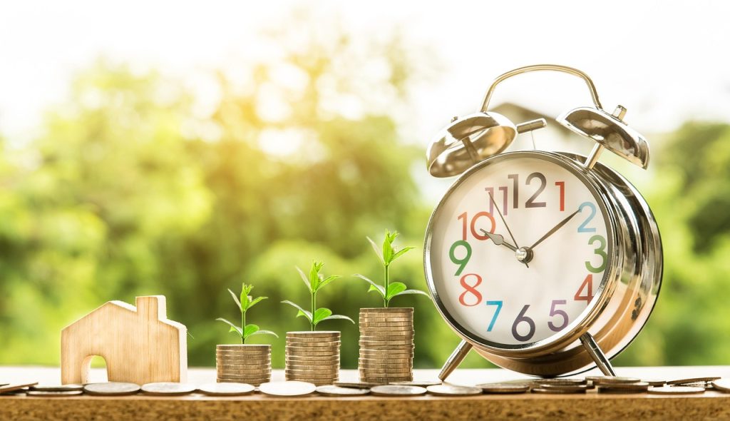 Cash, coins, and financial documents arranged together representing money, loans, savings, and banking concepts.