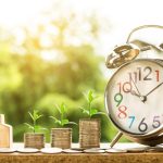 Cash, coins, and financial documents arranged together representing money, loans, savings, and banking concepts.