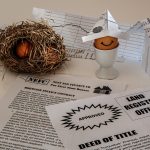 Finance documents, a mortgage contract, and savings materials arranged together representing a home loan process.